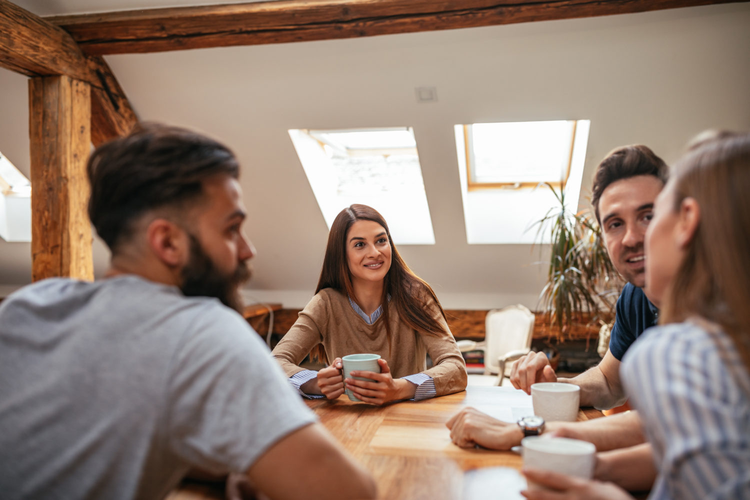 Group of friends chatting over coffee at home