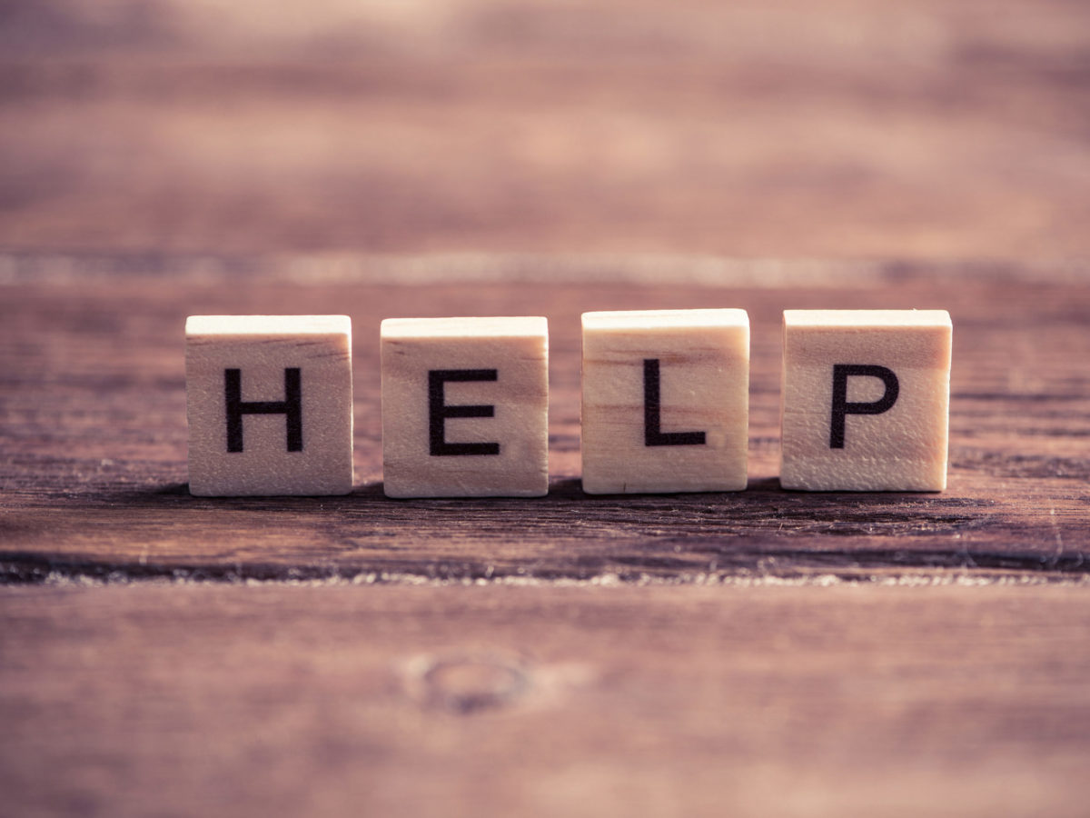 Alphabet letters on wooden pieces collected to word help